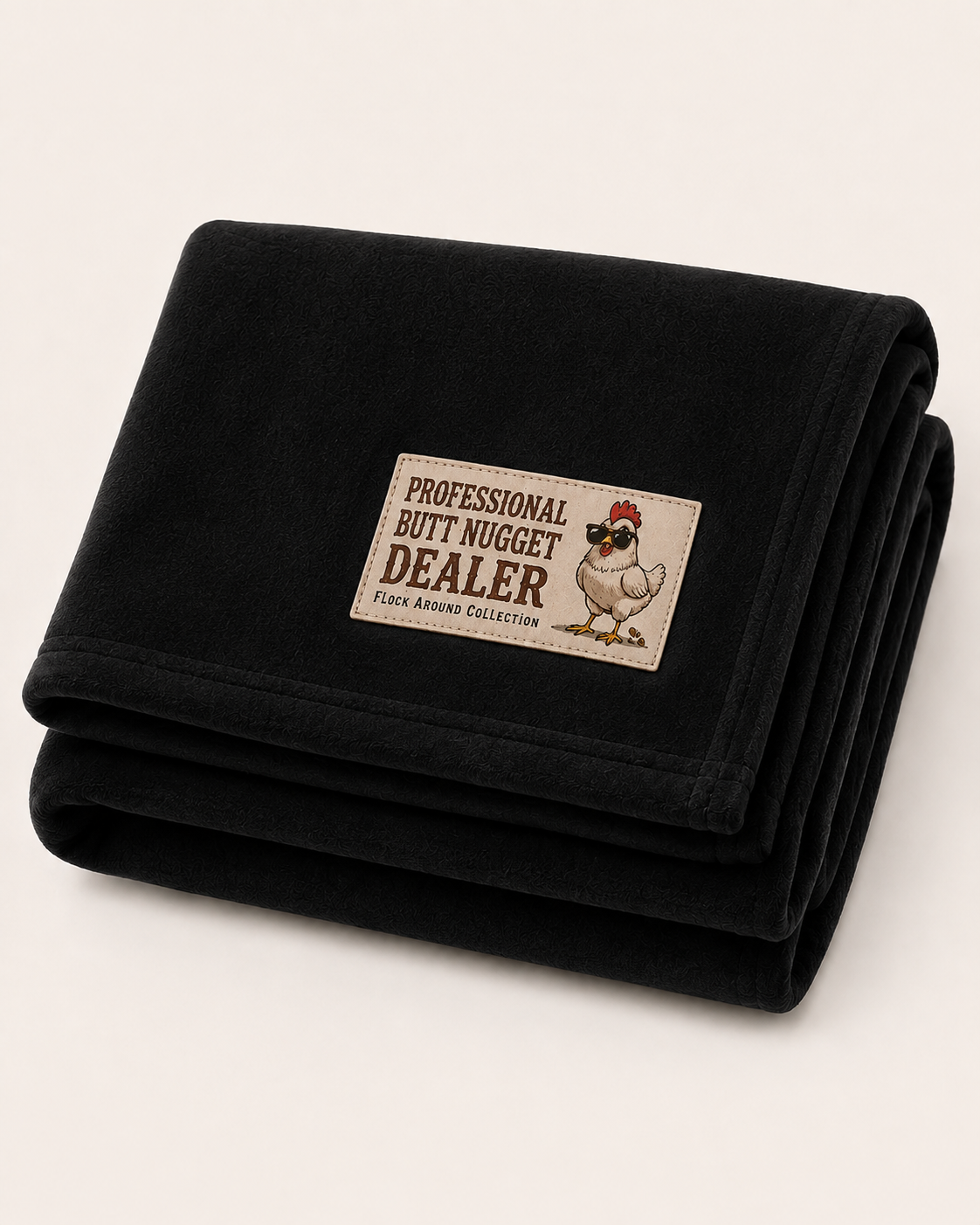 Flock Around fleece stadium blanket in black, folded, with Professional Butt Nugget Dealer patch