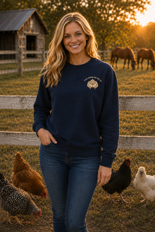 Woman wearing navy Flock Around and Find Out sweatshirt on the farm