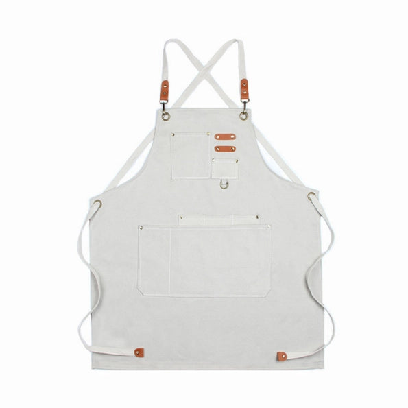Cream canvas chore apron full flat view with crossback straps and pockets