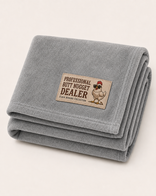 Flock Around fleece stadium blanket in heather grey, folded, with Professional Butt Nugget Dealer patch