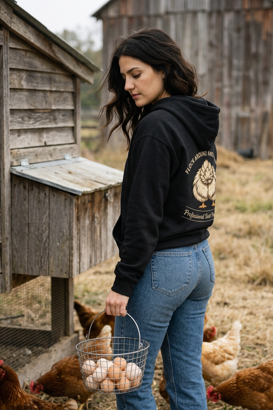 Model in black hoodie collecting eggs at the coop